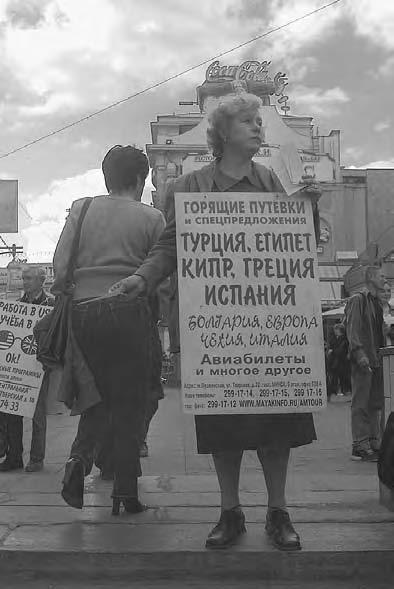 CONSUMER CULTURE 345 People carrying advertising boards for lastminute holidays on Pushkin Square, Moscow, in 2001.