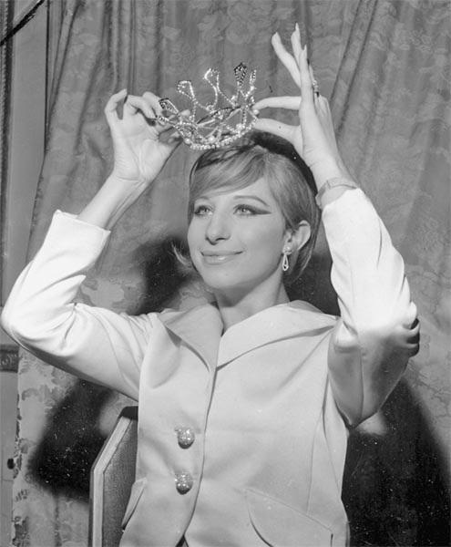 Barbra Streisand poses after being crowned Miss Ziegfeld of 1965 at the Ziegfeld Club Ball at New York's Waldorf Astoria Hotel in 1964.