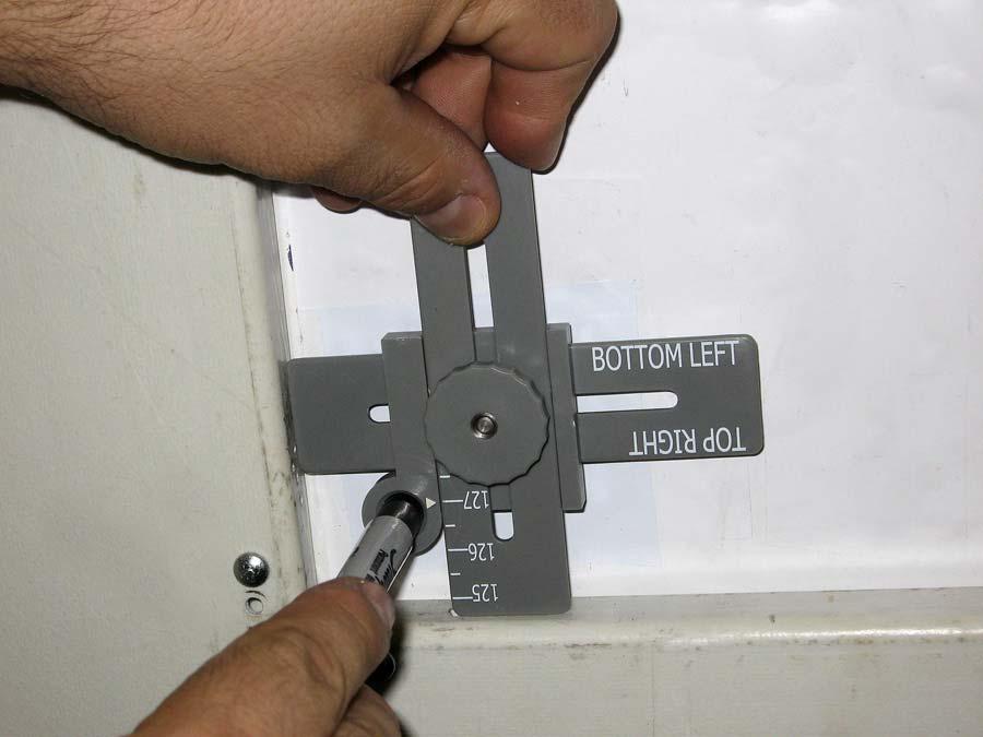 Align the arrow on the Corner Measurement Tool with the vertical measurement of the poster panel and lock in the setting.