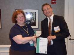 Director at Emerald Dr Larry White (left) accepts his Library Review Highly Commended Award from Bill Russell Ms