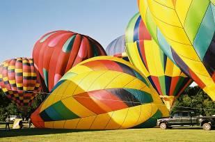 Hear the roar of burners being ignited as special shapes and colorful balloons inflate and glow against