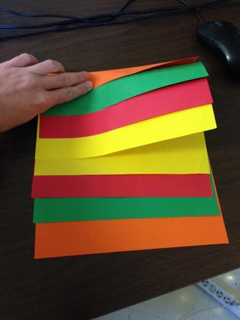 Take one piece of each color of paper Place the first sheet on the bottom