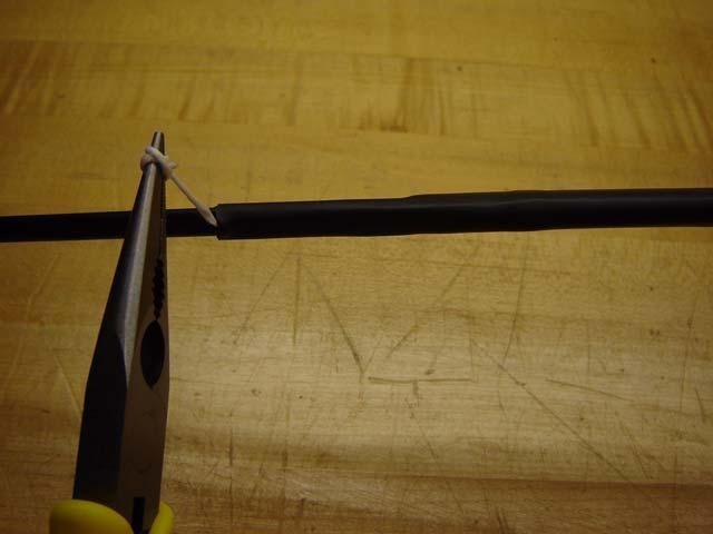 4. Wind the rip cord around a needle nose pliers, as shown in Figure 12, and then
