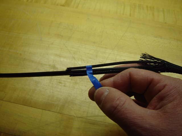 Remove tape to free the pulling sock from the cable as