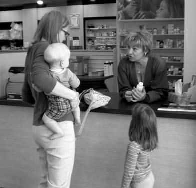 Medicine Carla is at the drugstore. She holds Tony because he is sick and crying. Five-yearold Becky is bored.