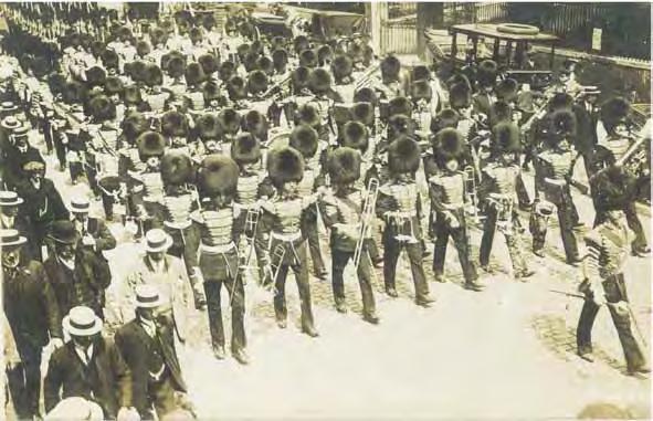 Mackenzie-Rogan (right side fronting the motor car) marches with