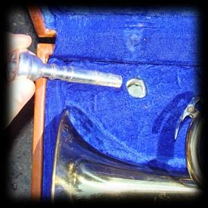 A loose mouthpiece can dent the trumpet as it rolls around in the case.