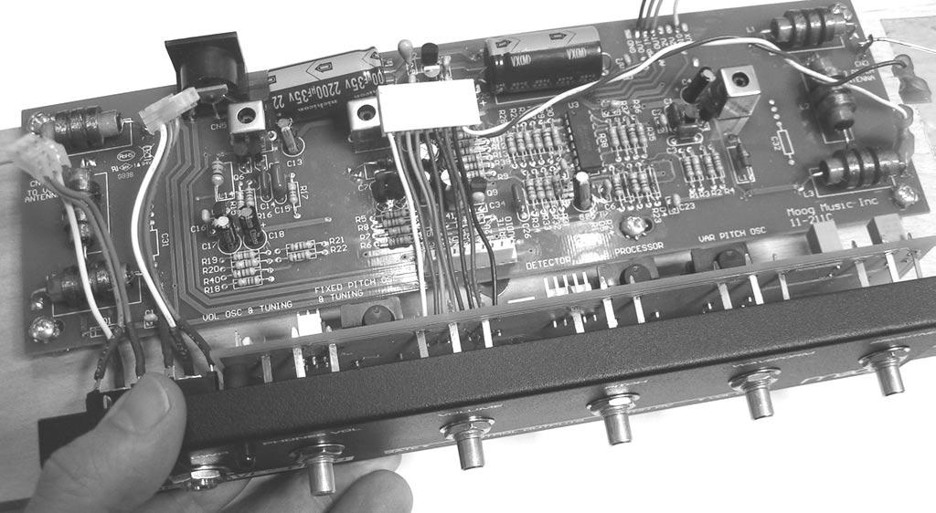 10) Slowly place the panel onto the front of the cabinet so the potentiometer leads stick through the appropriate pads on the 11-213 PCB (shown in figure 7).