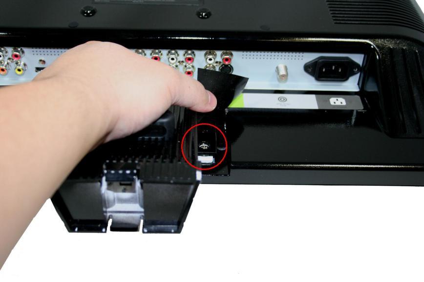 3. After the base comes off by unlocking both buckles peel off the sticker with the TV drawings that identifies the cable and cable clamp. 4.