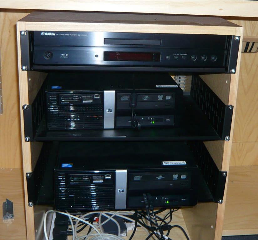 The top unit is the DVD player. Insert a DVD, set it to play with the controls on the box and select DVD from the AMX panel.