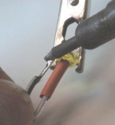 Hold the wire in place until the solder solidifies.