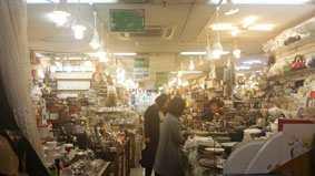 convenience goods, furniture, and a variety of household items imported from various countries around the world Shops are located on both sides of the large street between
