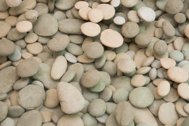 These pebbles manifest my attempt to appropriate the flawlessness of nature through the simplest of actions on the other hand, the artificial stones are about the pressure a human exerts against the
