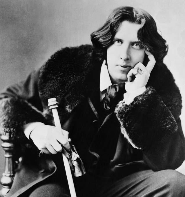 Oscar Wilde in a photo taken in 1854. The hair, the fur coat, the gloves and the walking cane are all signs of a dandy, a man who thinks a lot about his appearance.