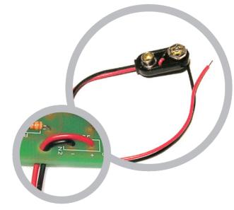 The red lead should be soldered to the + terminal and the black lead should be soldered to the - terminal.