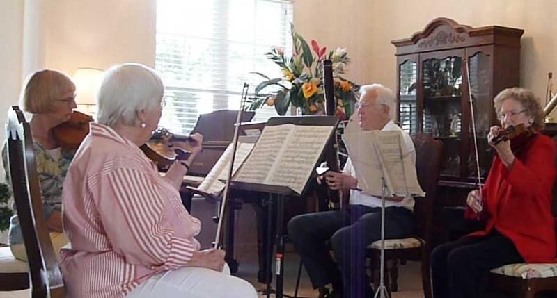 Peg Rowley, Linda Werner, Tom Draney and Phyllis Gryskiewicz, members of the Glissandos, perform for each other at Norma Farmilo's home on March 1, 2012 "We're so proud and pleased to have 50 members