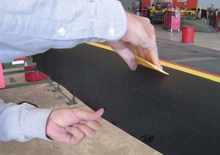 8.) Spray the surface of the adhesive liberally with the 3M Protective Tape Solution. Flip the 3M Polyurethane Protective Tape 8663MB down and into position.