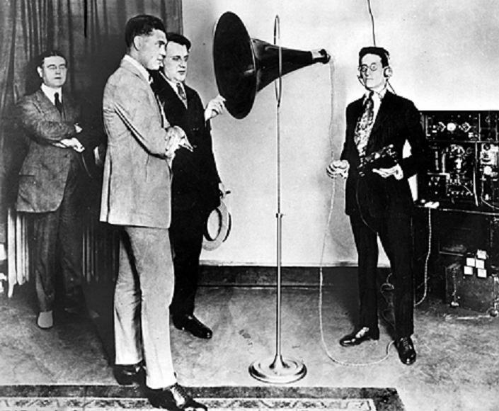 American heavyweight Boxer, Jack Dempsey, speaks into the microphone at the CFCF radio station in Montreal - 1922 Source: City