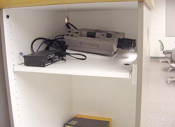 Be sure to push the shelf all the way back in to ensure that the lens is projecting through the opening in the front of the cabinet.. The enclosures are on wheels.
