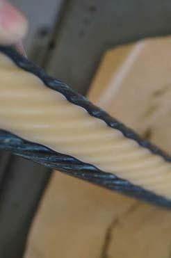 The scalloped deformation occurred as the cable insulation expanded and pressed into the surrounding wires, which were removed before taking the photo.