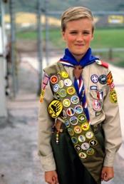 By wearing his Scout uniform, this boy