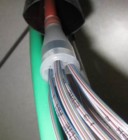 If the ribbon funnel kit inside diameter is larger than the outside diameter of the cable, use electrical tape to build up the outside diameter of the cable jacket so the ribbon funnel kit fits on