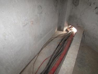 E-25 CATEGORY: Cable & Cable Support Cable passed through permanent wall not protected.