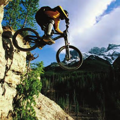 Downhill mountain bikers ride under / down / into huge mountains (photo B). They use a mountain bikes. b hill bikes. c BMX bikes.