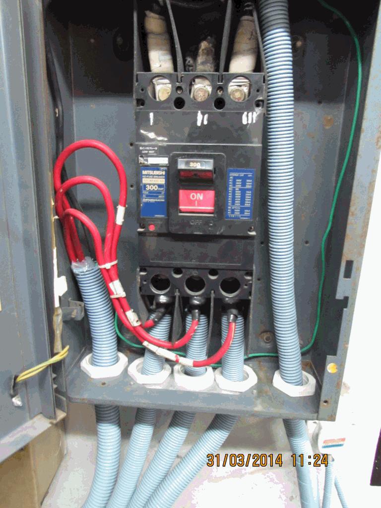 Wires are crowded inside the common busbar panel.