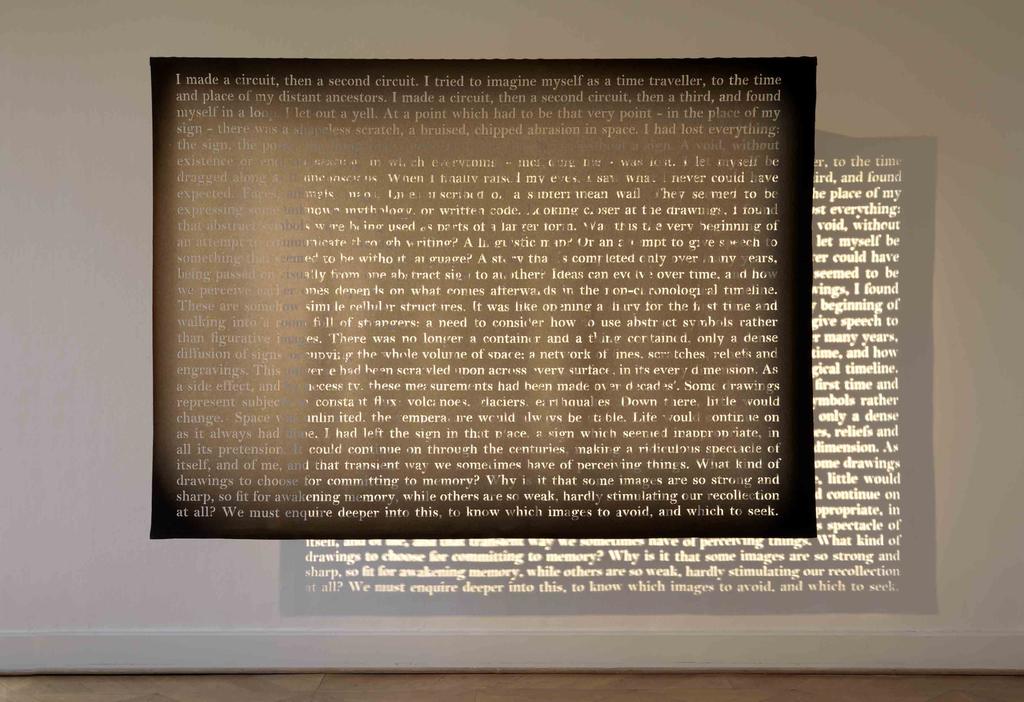 Barba has cut the letters from a text. The prose only becomes legible when the beam of a spotlight illuminates the absent letters, as though the object was a modern-day illuminated manuscript.