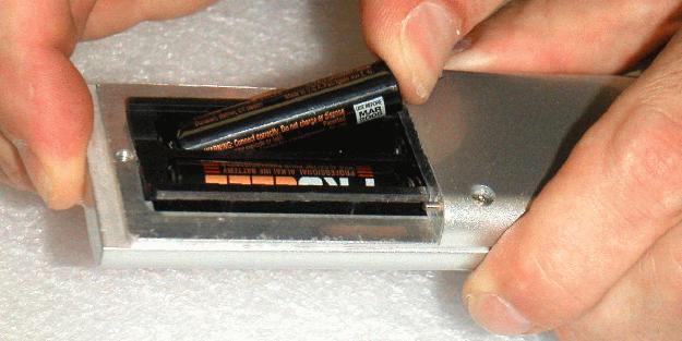 To install or change batteries, first loosen the screw on the back of the remote.