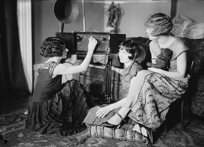 Photograph of the Brox Sisters, a popular singing trio, listening to the radio together in the mid 1920s.
