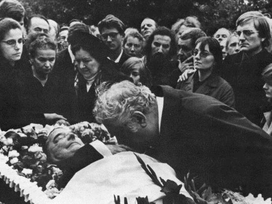 A scene from Dmitri Shostakovich s 1975 funeral in Moscow s Novodevichy Cemetery. Composer Aram Khachaturian is seen kissing the composer's hand.